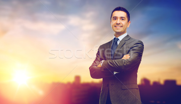 happy smiling businessman over city background Stock photo © dolgachov