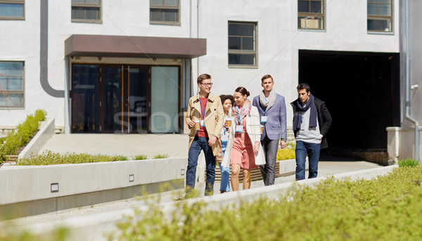 office workers with coffee walking in city Stock photo © dolgachov