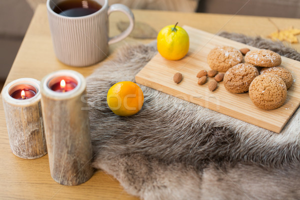 cookies, lemon tea and candles on table at home Stock photo © dolgachov