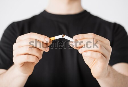 man breaking the cigarette with hands Stock photo © dolgachov