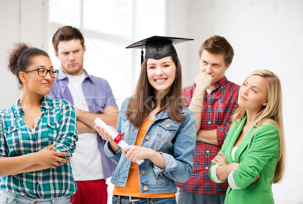 girl in graduation cap with certificate Stock photo © dolgachov