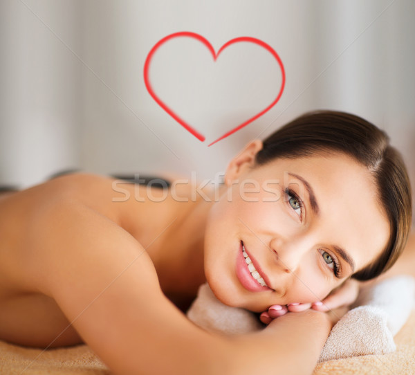 Stock photo: beautiful woman in spa salon with hot stones