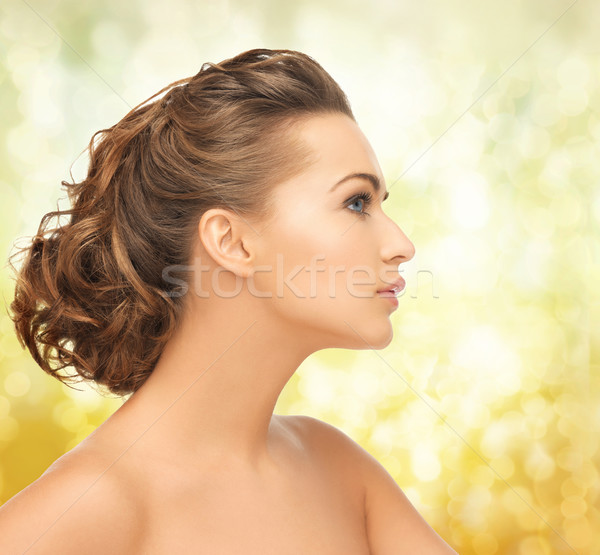 beautiful woman with updo Stock photo © dolgachov