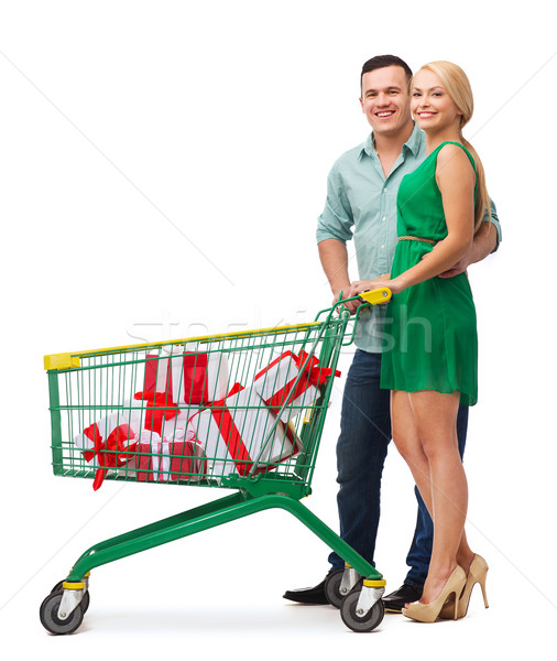 smiling couple with shopping cart and gift boxes Stock photo © dolgachov
