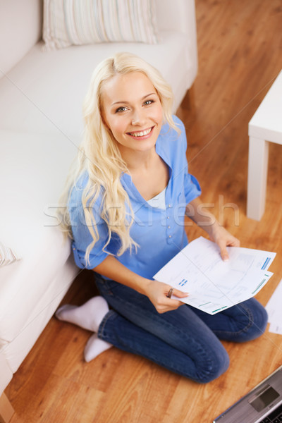 smiling woman with papers, laptop and calculator Stock photo © dolgachov