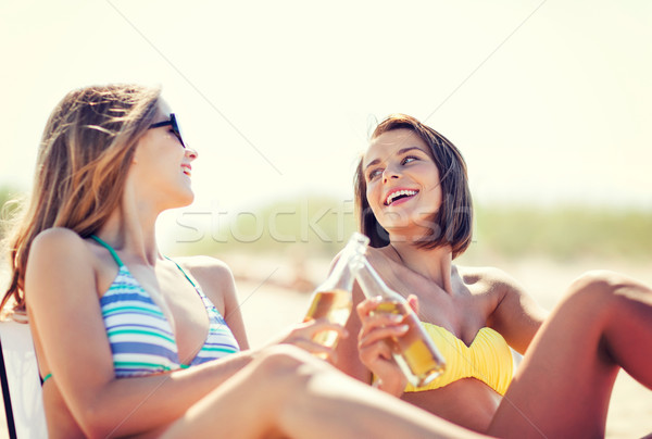 girls with drinks on the beach chairs Stock photo © dolgachov