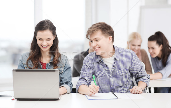 students with laptop and notebooks at school Stock photo © dolgachov