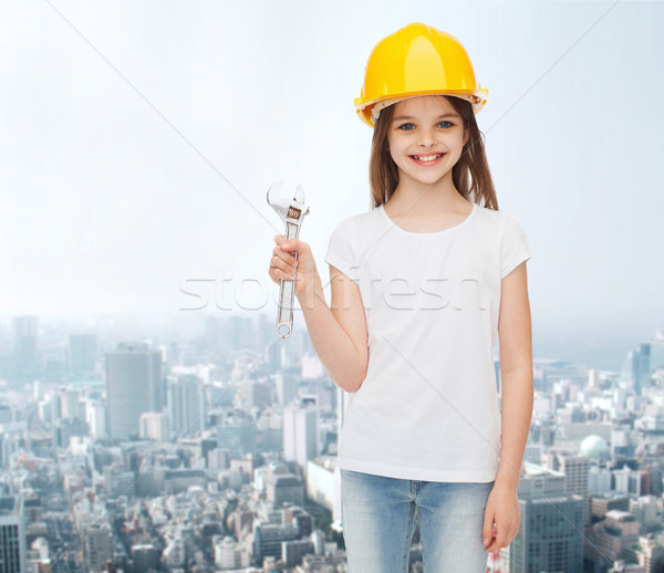 smiling little girl in hardhat with wrench Stock photo © dolgachov