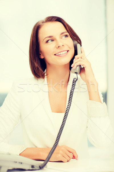 businesswoman with phone in office Stock photo © dolgachov
