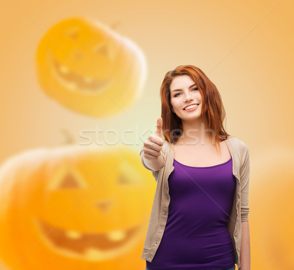 Stock photo: smiling teenage girl showing thumbs up