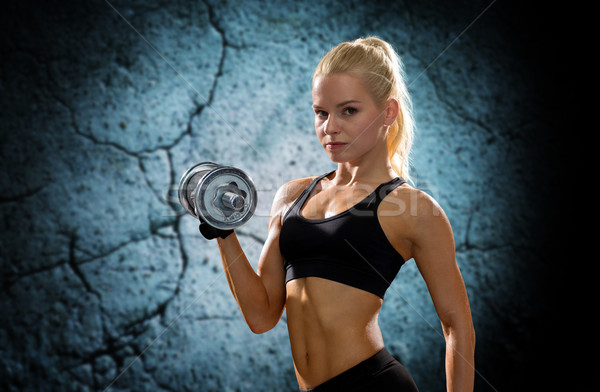 young sporty woman with heavy steel dumbbell Stock photo © dolgachov