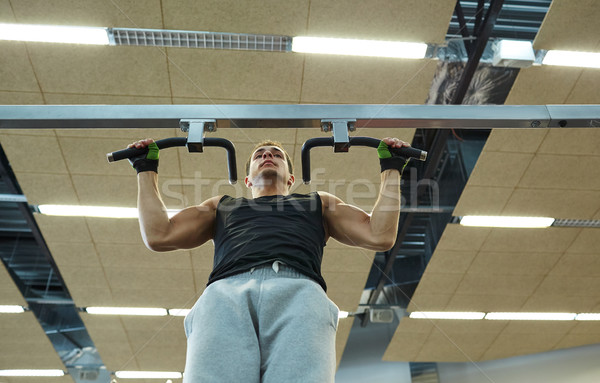 young man exercising in gym Stock photo © dolgachov