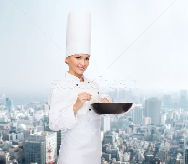 Uśmiechnięty kobiet kucharz pan łyżka gotowania Zdjęcia stock © dolgachov