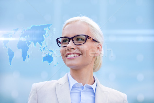 young smiling businesswoman in eyeglasses outdoors Stock photo © dolgachov