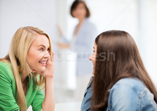 Stock photo: student girls gossiping at school