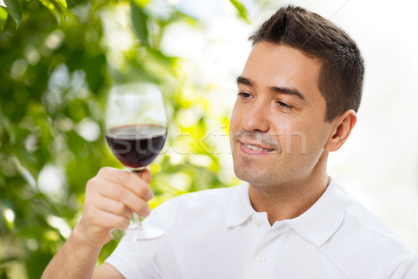 happy man drinking red wine from glass Stock photo © dolgachov