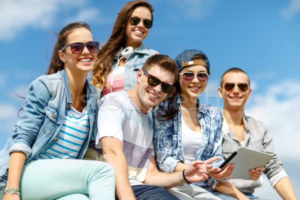 Stock photo: group of teenagers looking at tablet pc computer