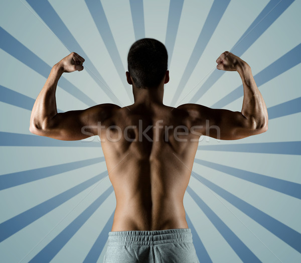 Stock photo: young man or bodybuilder showing biceps