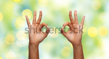 hands showing ok sign over rainbow background Stock photo © dolgachov