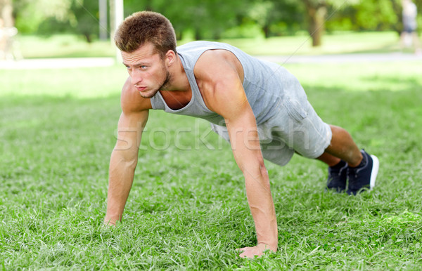 Jeune homme herbe été parc fitness [[stock_photo]] © dolgachov