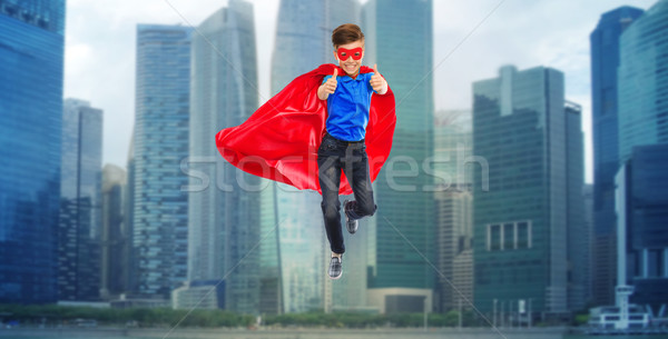 boy in super hero cape and mask showing thumbs up Stock photo © dolgachov