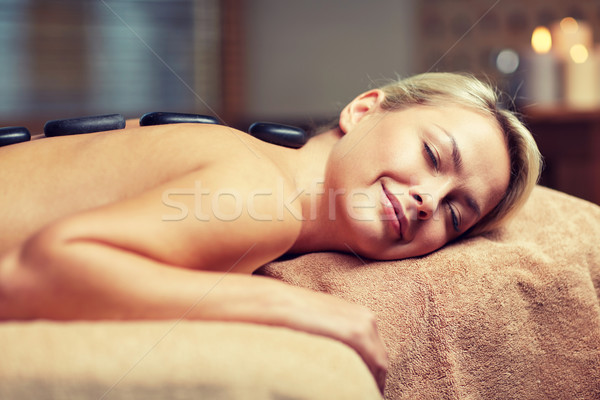 close up of woman having hot stone massage in spa Stock photo © dolgachov