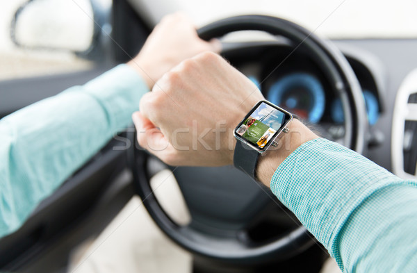 close up of male hands with smartwatch driving car Stock photo © dolgachov
