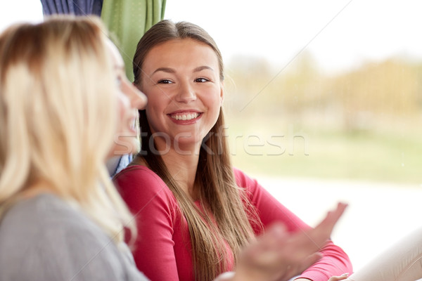 Stock photo: happy young women talking in travel bus or train