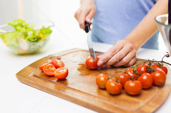close up of woman chopping tomatoes with knife Stock photo © dolgachov