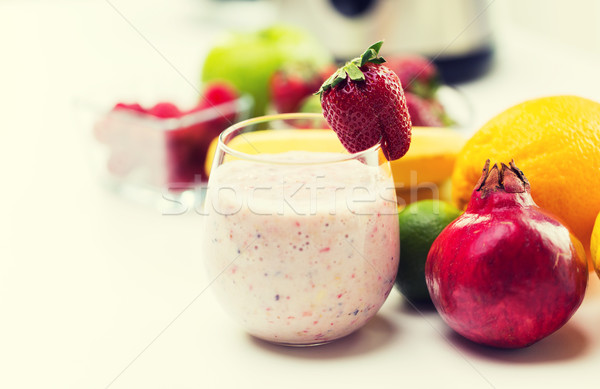 close up of glass with milk shake and fruits Stock photo © dolgachov