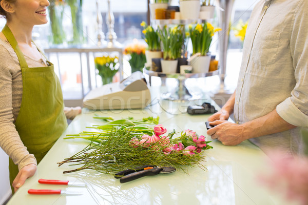 Stock photo: close up of florist woman and man at flower shop