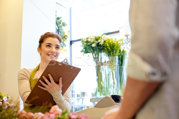 florist woman and man making order at flower shop Stock photo © dolgachov