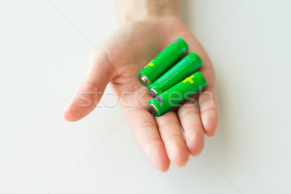 close up of hand holding green alkaline batteries Stock photo © dolgachov