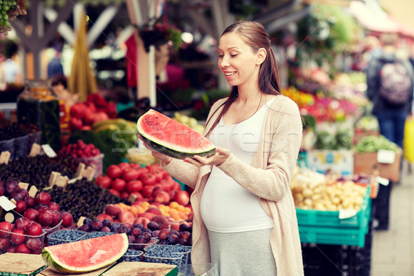 pregnant woman holding watermelon at street market Stock photo © dolgachov