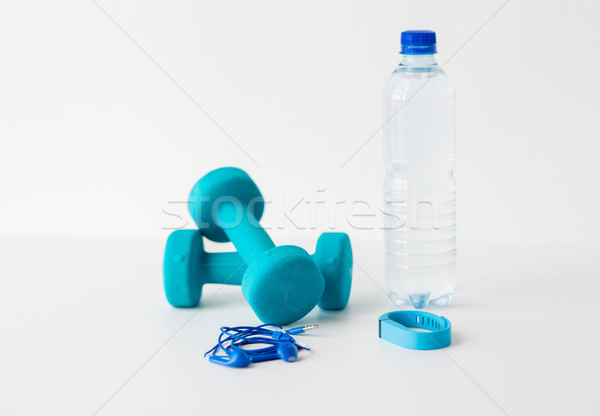 dumbbells, fitness tracker, earphones and bottle Stock photo © dolgachov