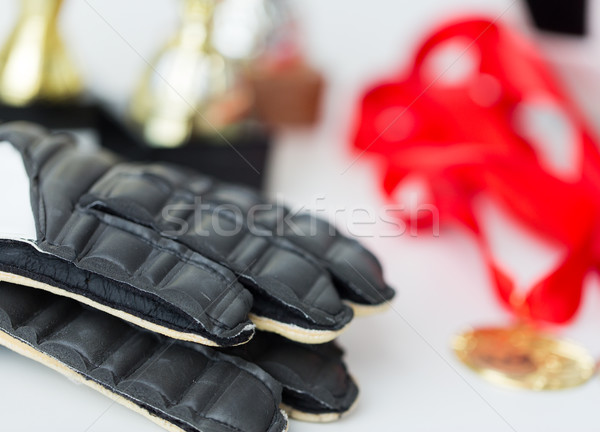 close up of football, gloves, cups and medals Stock photo © dolgachov