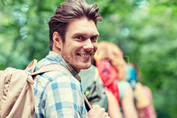 group of smiling friends with backpacks hiking Stock photo © dolgachov