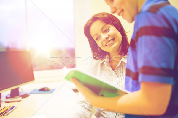 school boy with notebook and teacher in classroom Stock photo © dolgachov
