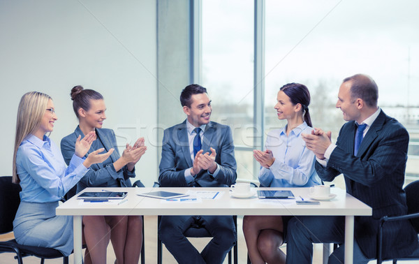 business team with laptop clapping hands Stock photo © dolgachov
