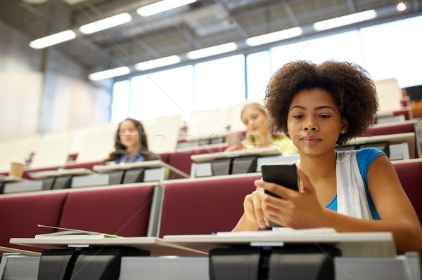 african student girl with smartphone at lecture Stock photo © dolgachov