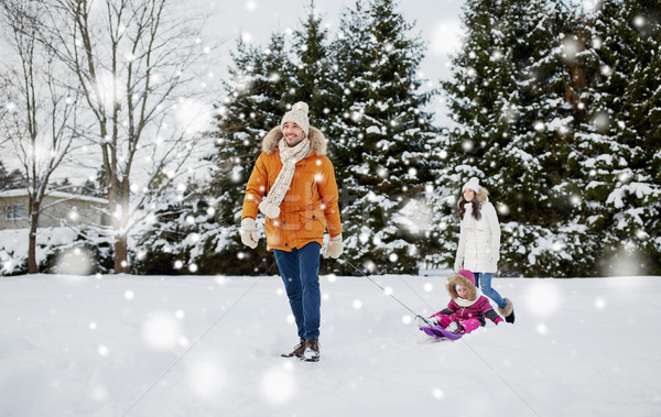 happy family with sled walking in winter outdoors Stock photo © dolgachov