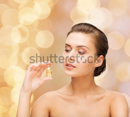 woman with moisturizing cream on hand over snow Stock photo © dolgachov