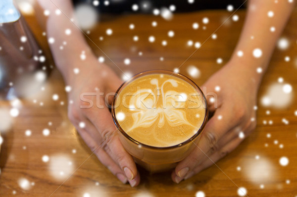 close up of hands with latte art in coffee cup Stock photo © dolgachov