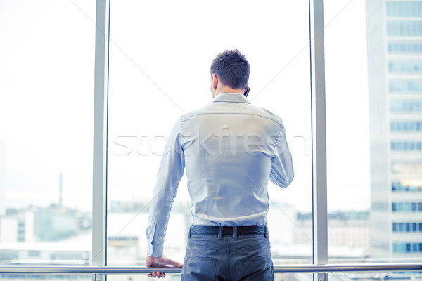 businessman calling on smartphone in office Stock photo © dolgachov