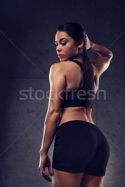 Jeune femme posant gymnase sport [[stock_photo]] © dolgachov