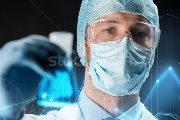 close up of scientist holding flask with chemical Stock photo © dolgachov