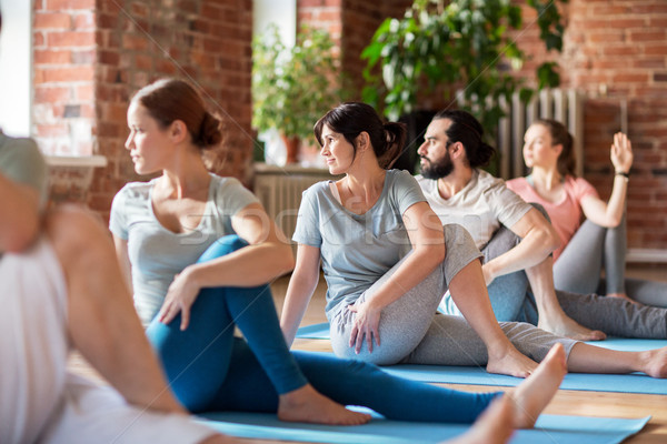 group of people doing yoga exercises at studio Stock photo © dolgachov