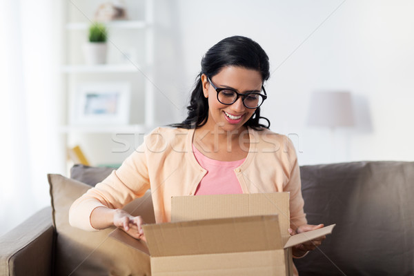 happy young indian woman with parcel box at home Stock photo © dolgachov