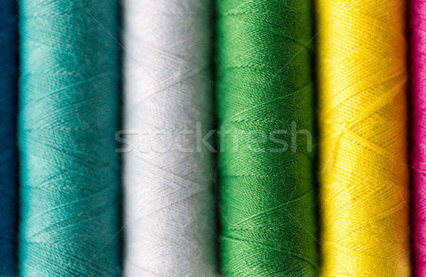 row of colorful thread spools on table Stock photo © dolgachov