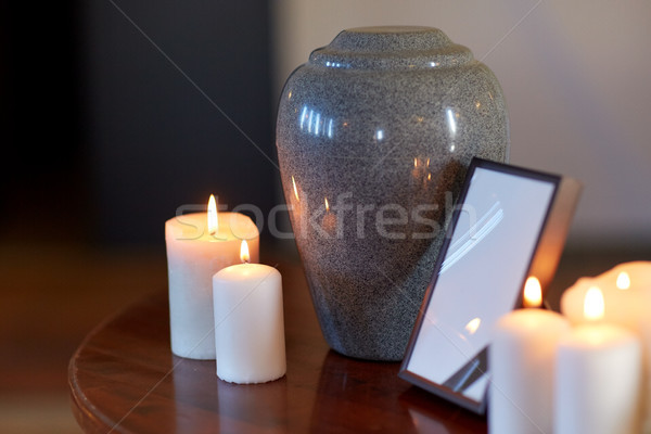 photo frame, cremation urn and candles on table Stock photo © dolgachov